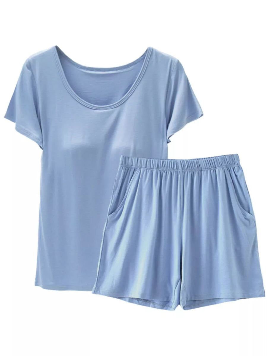 Light blue short sleeve pajama set with scoop neck top and elastic waist shorts with pockets.