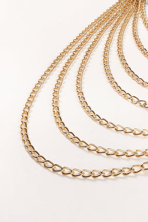 Cascading gold chain waist harness with multiple strands of aluminum links.