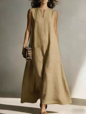 Maxi dress in beige linen blend with V-neck, sleeveless, and two large front pockets.