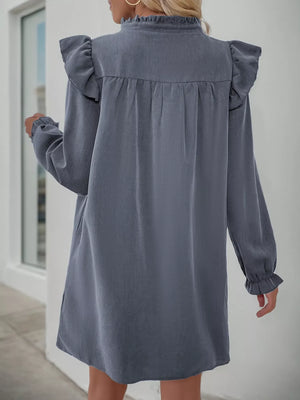 Dark gray cotton blend dress with ruffled neckline and sleeves, long sleeves, and cinched waist detail.