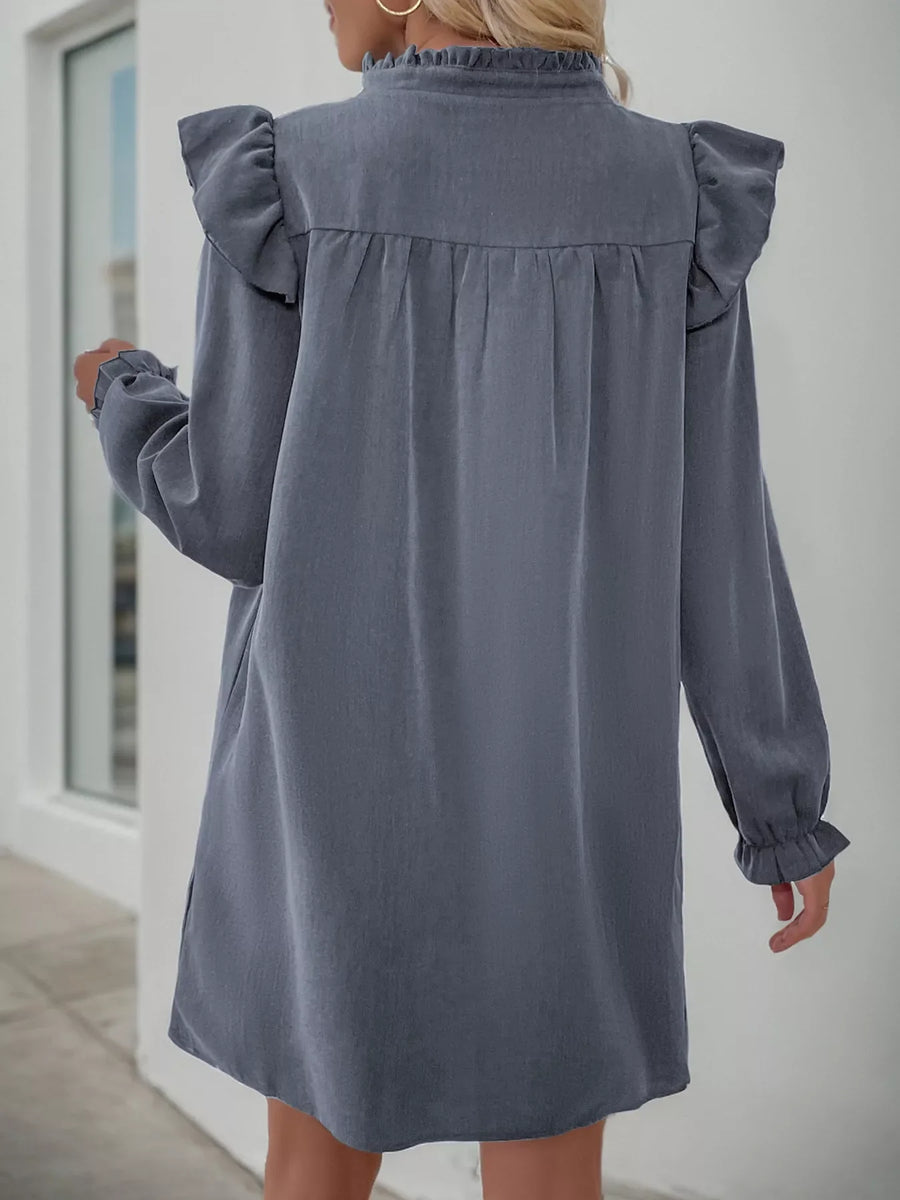 Dark gray cotton blend dress with ruffled neckline and sleeves, long sleeves, and cinched waist detail.