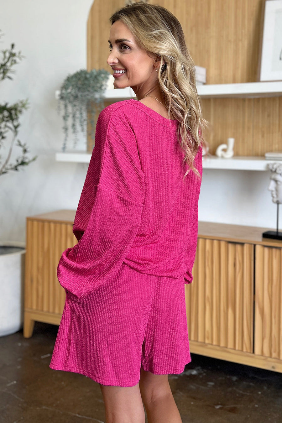 Waffle knit lounge set in hot pink with blouson sleeves and shorts.