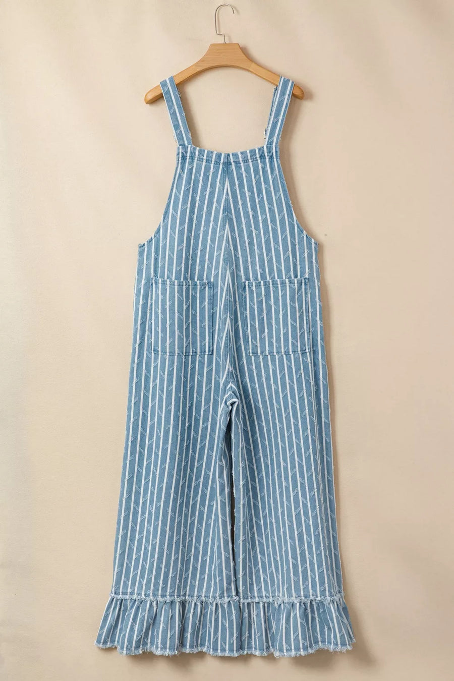 Striped denim overalls with wide legs, distressed details, and ruffled hem.