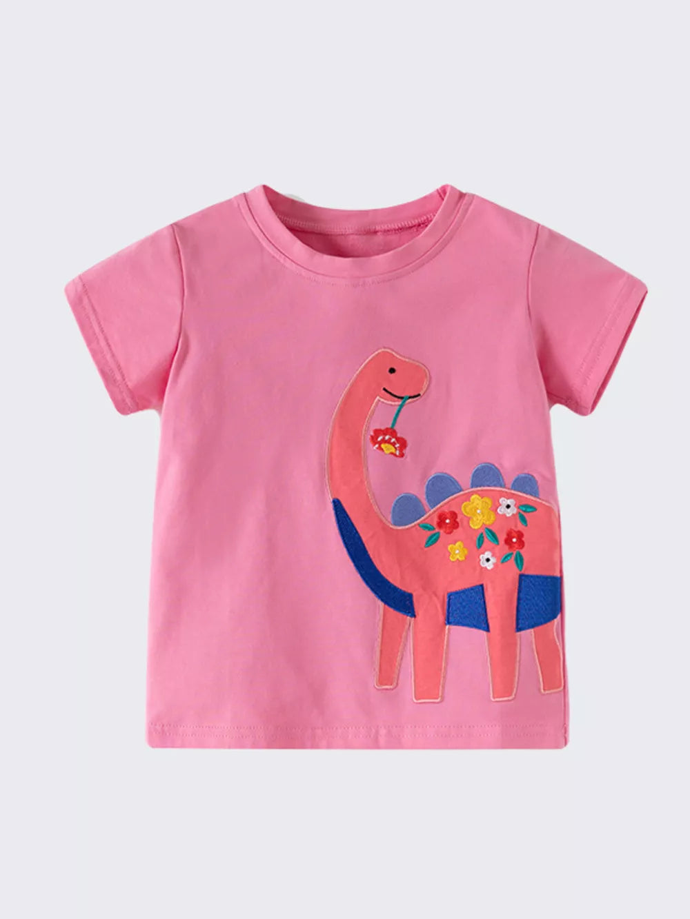 Pink cotton t-shirt for kids with a pink dinosaur embroidered with flowers and blue accents.
