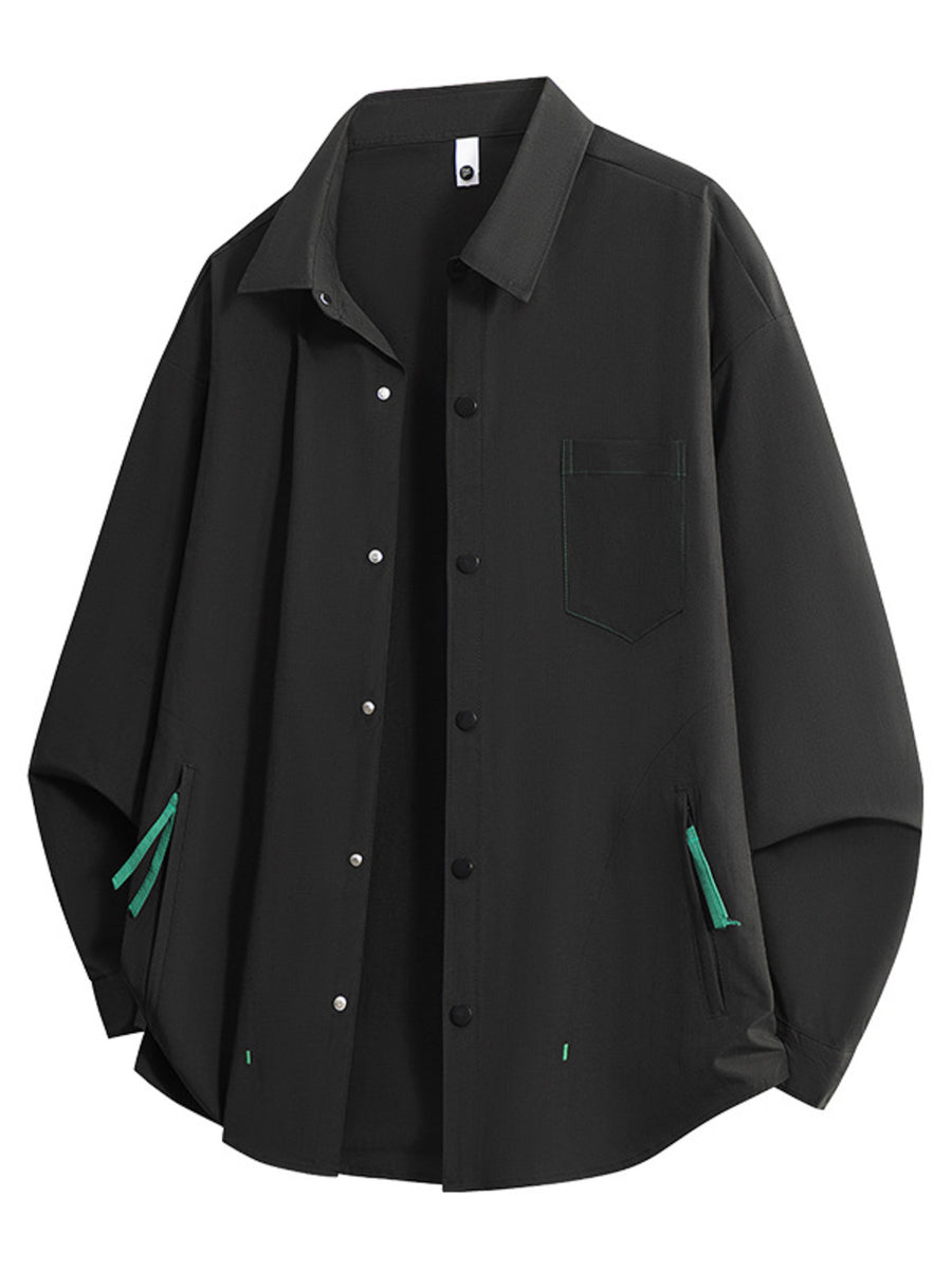 Black long sleeve button-up shirt with chest pocket and green zipper accents