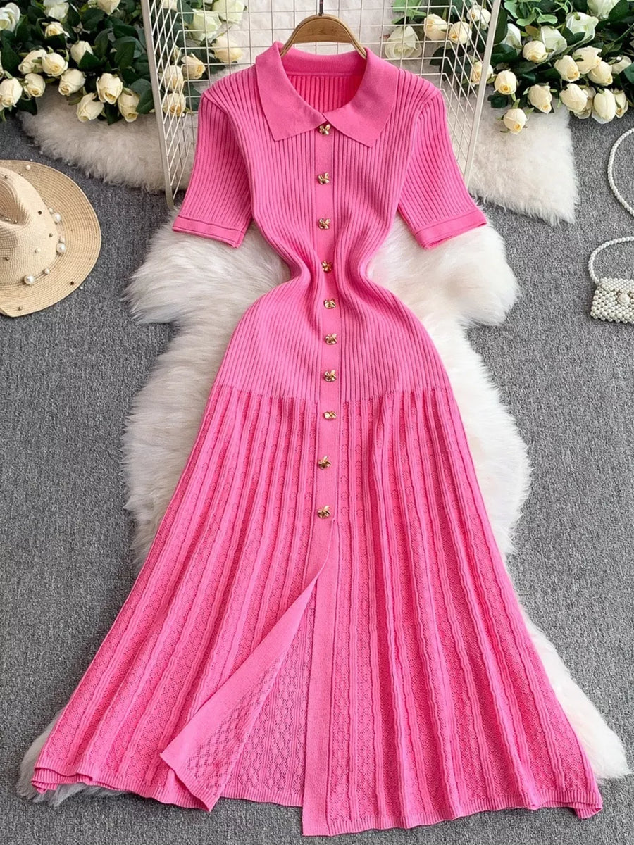 Pink ribbed knit midi dress with collar, short sleeves, and gold button detail.