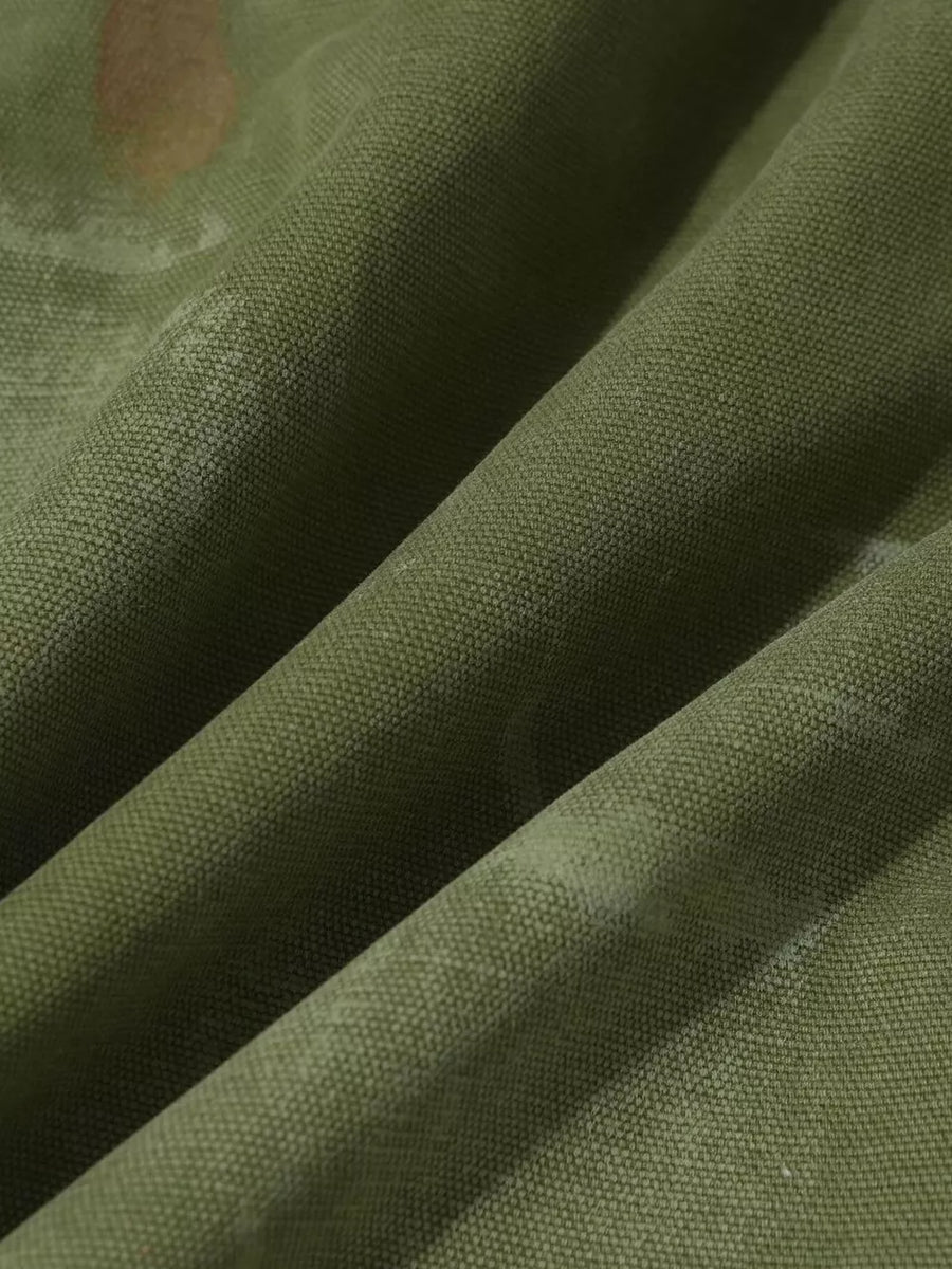 Green distressed cargo pants with subtle accents and textured polyester-spandex fabric.