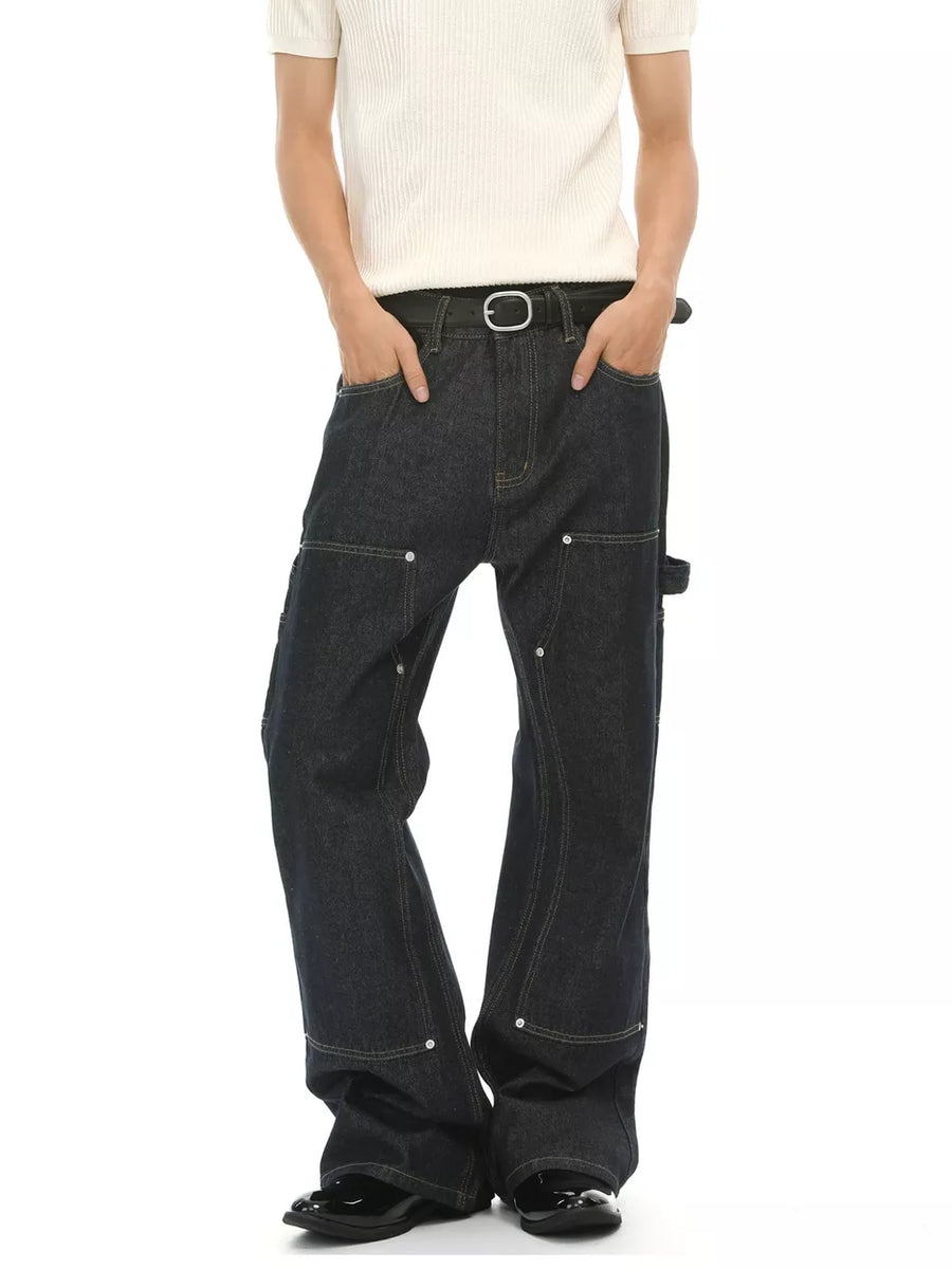 Dark wash cotton blend carpenter jeans with contrast stitching and distinctive pockets.