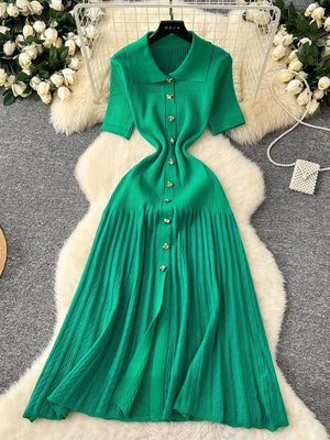 Green knit dress with Peter Pan collar, short sleeves, and button front.