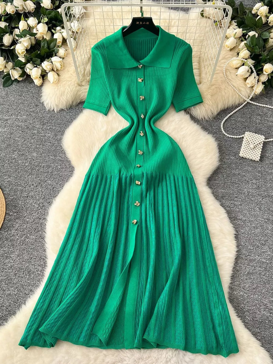 Green knit dress with Peter Pan collar, short sleeves, and button front.