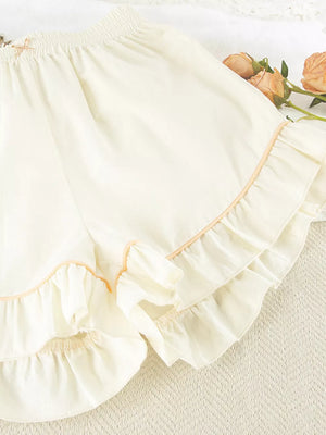 pajama set in cream with buttoned and hip-length top, mini shorts