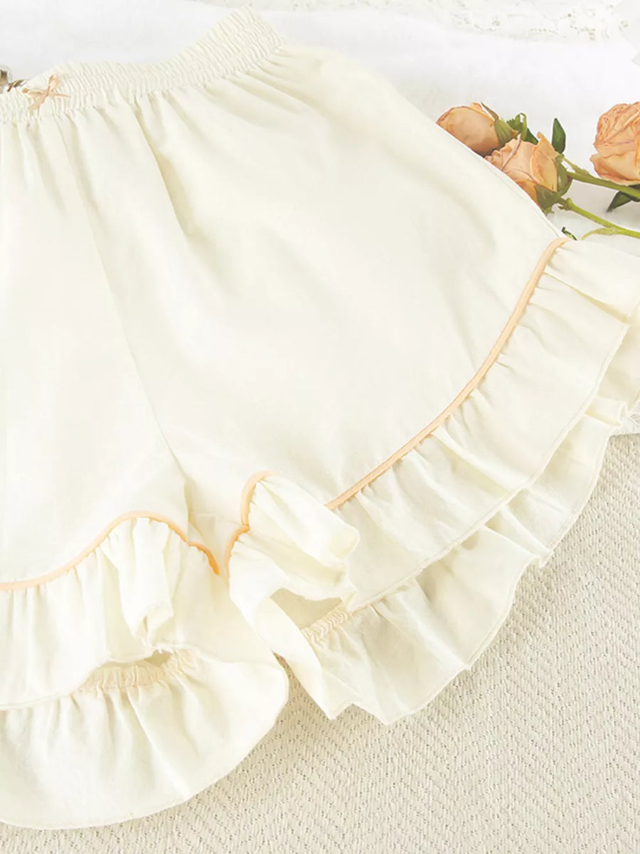 pajama set in cream with buttoned and hip-length top, mini shorts