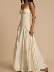 Elegant ivory sweetheart neck maxi dress with spaghetti straps and flowing skirt.