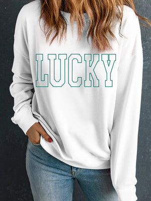 White crewneck sweatshirt with green varsity "LUCKY" graphic