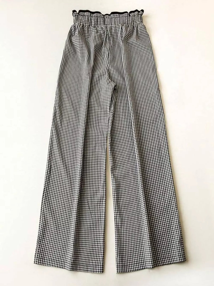 High-waisted wide-leg gingham pants with a ruffled black waistband.