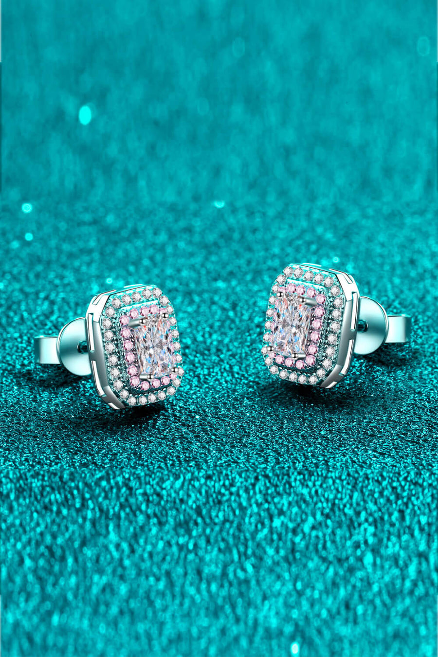 Radiant Emerald-Cut Halo Studs in silver with pink and clear accents.