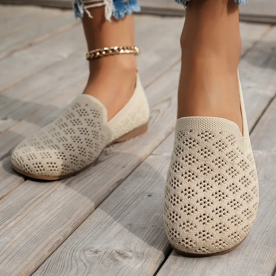 Beige diamond knit loafers with a perforated pattern, worn with a gold anklet.