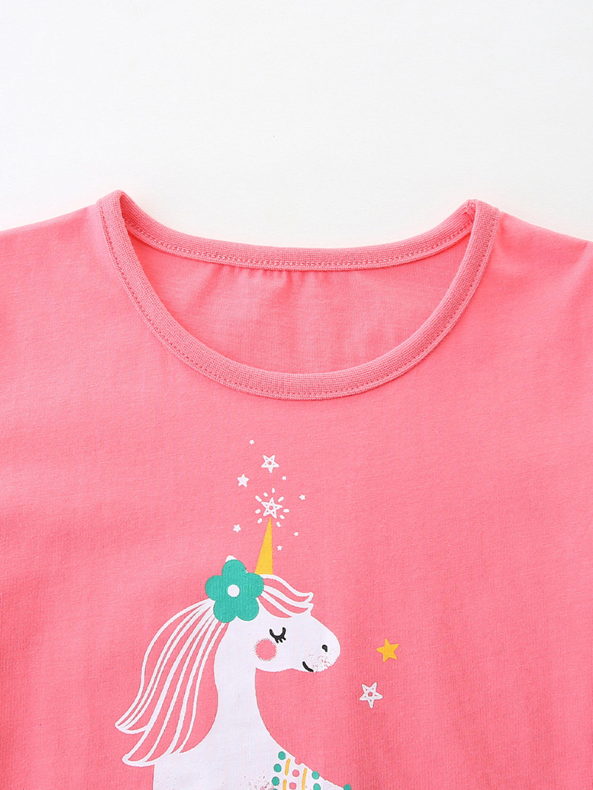 Pink cotton toddler t-shirt with a unicorn graphic and crew neck.