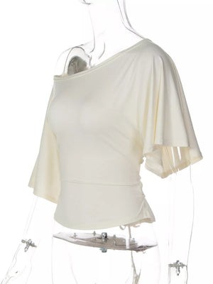 Apricot draped tie-front short sleeve t-shirt with dolman sleeves and asymmetrical hem.