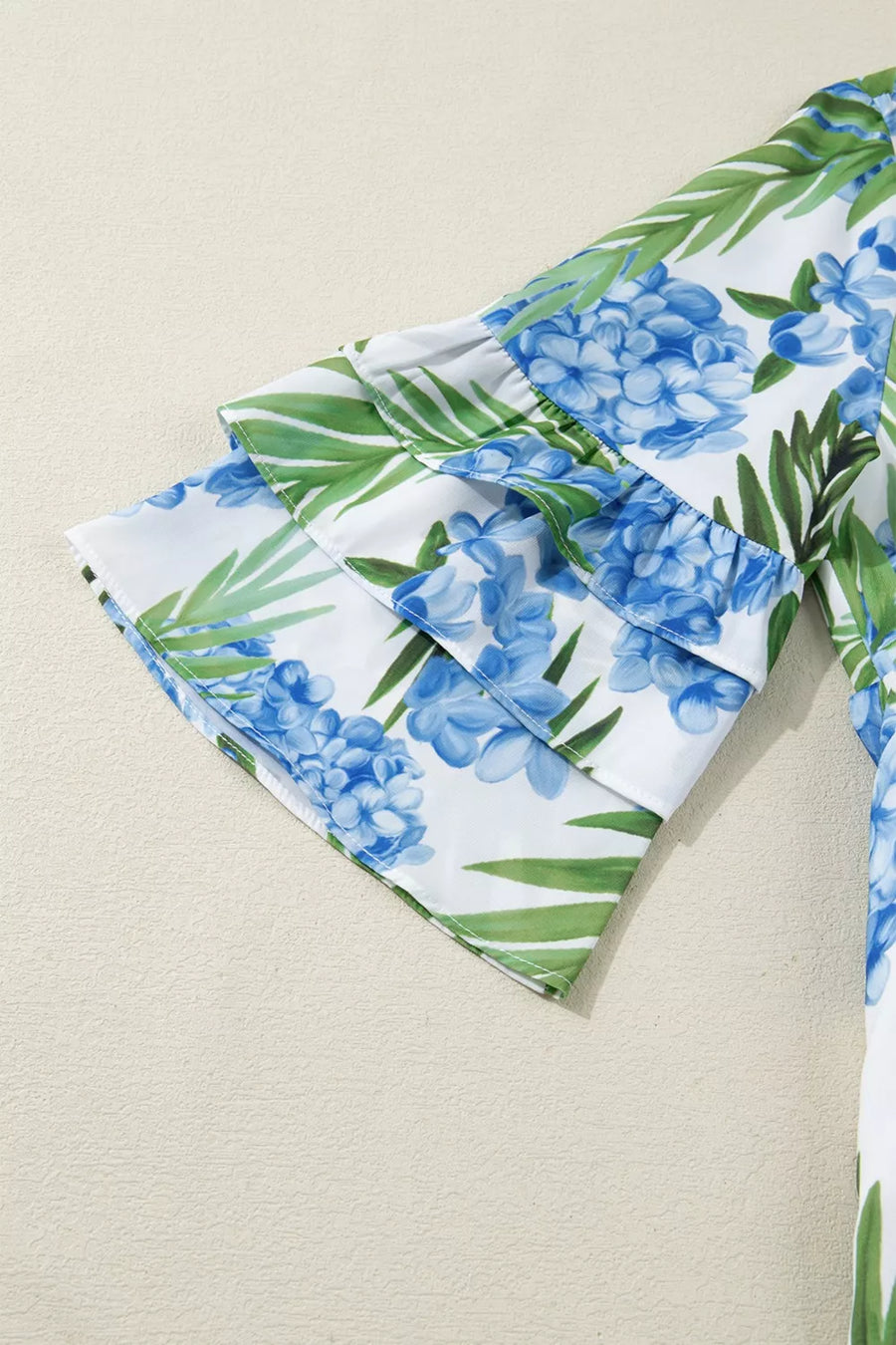 Mini dress with hydrangea and palm print, featuring ruffled short sleeves.