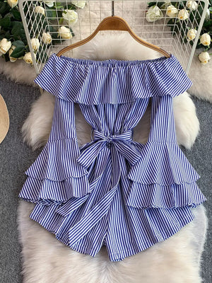 Blue striped off-shoulder romper with ruffled tiers and a bow belt.