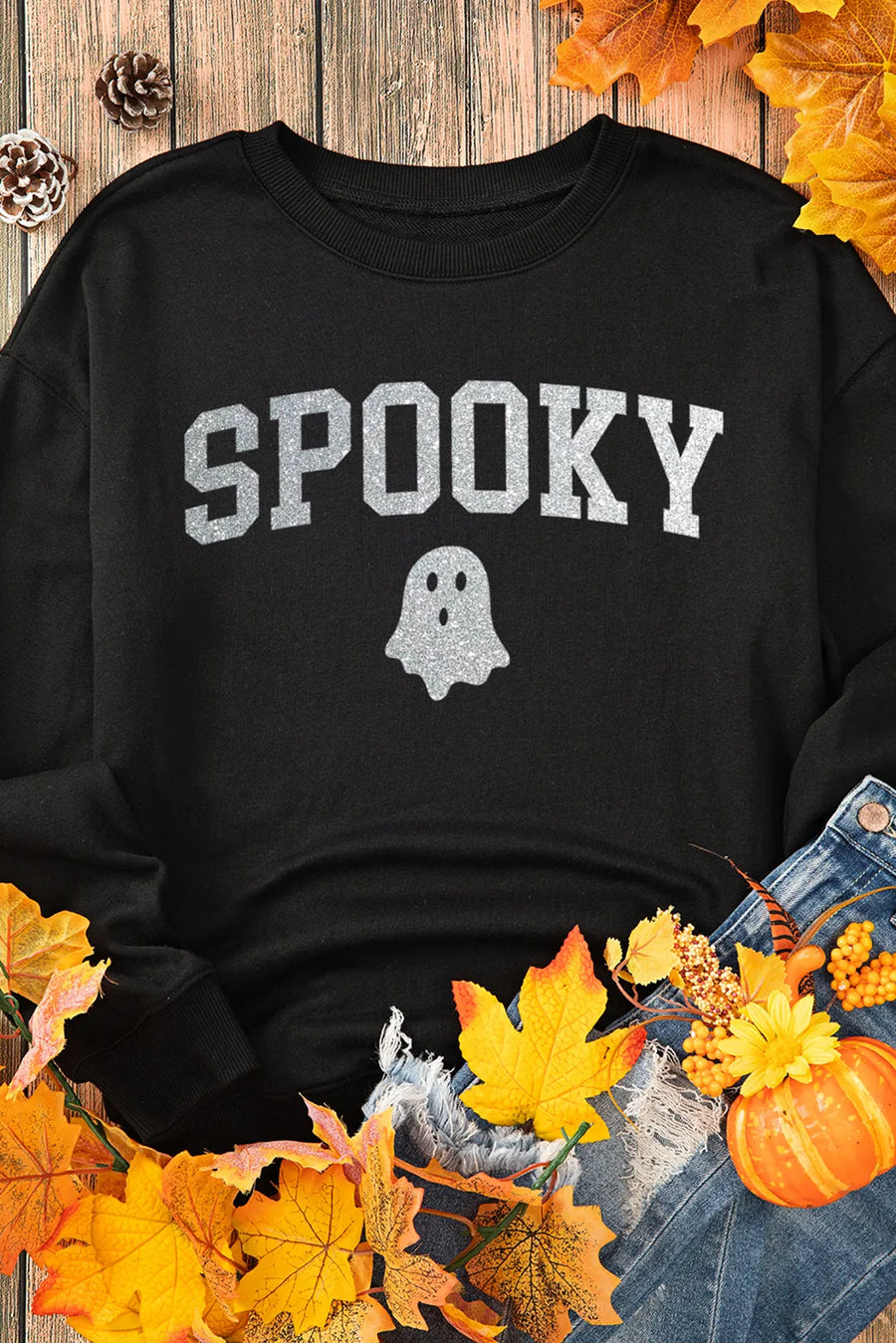 Black crewneck sweatshirt with glitter "Spooky" graphic and ghost detail.