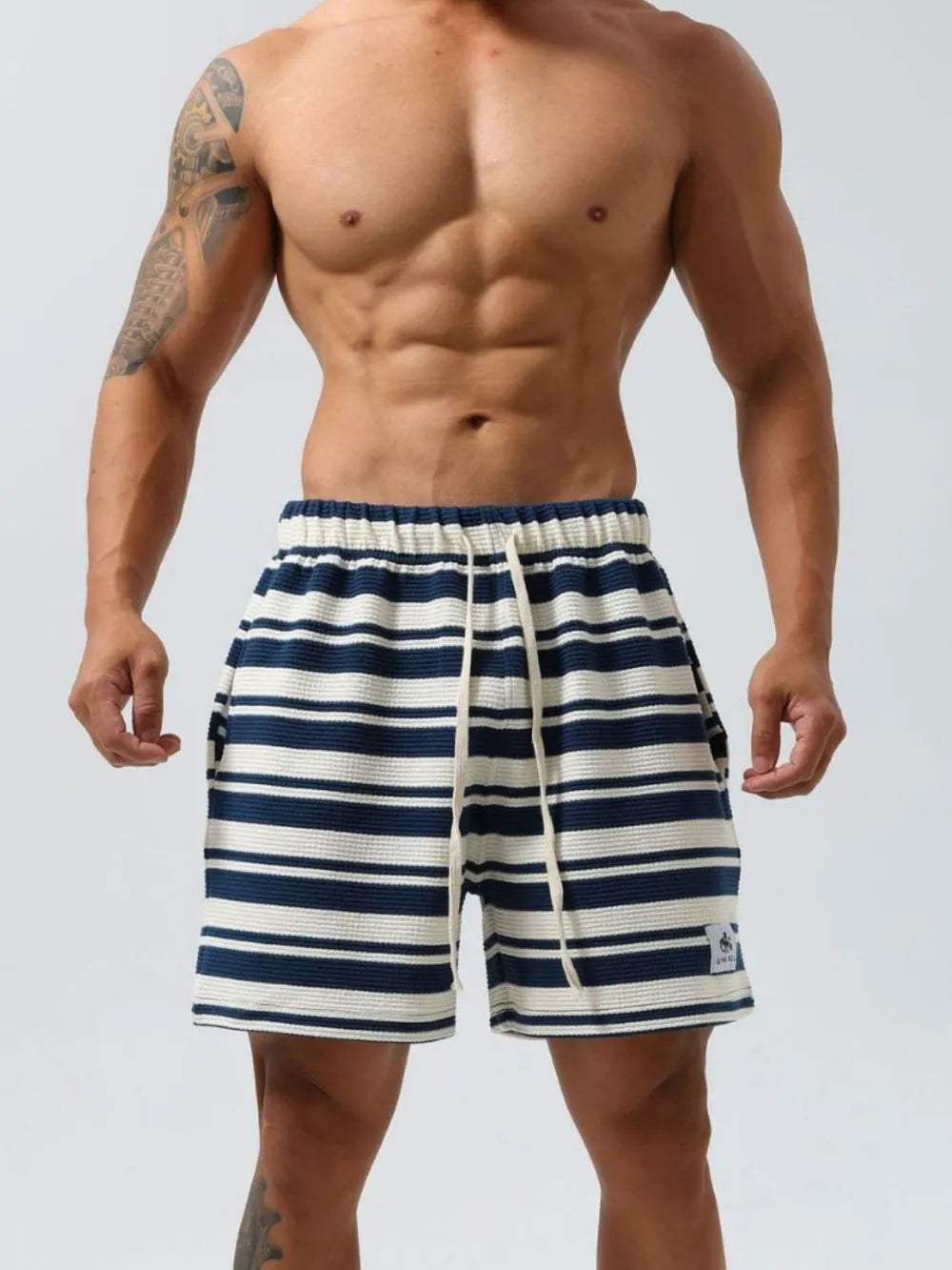 Navy and white striped textured jogger shorts with drawstring and elastic waistband.