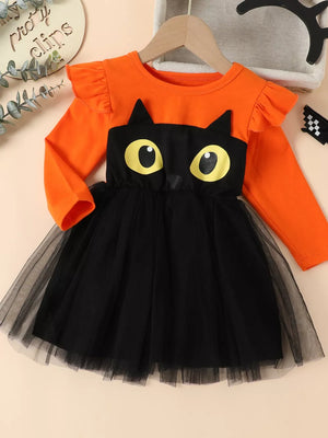 orange dress featuring ruffled and graphic