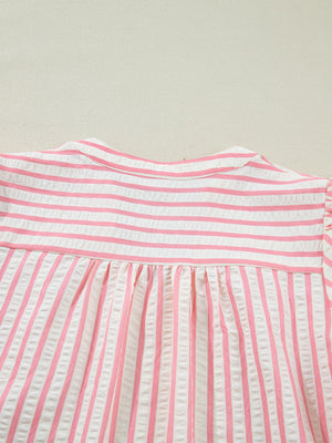 Pink and white striped textured blouse with gathered yoke and puff sleeves.
