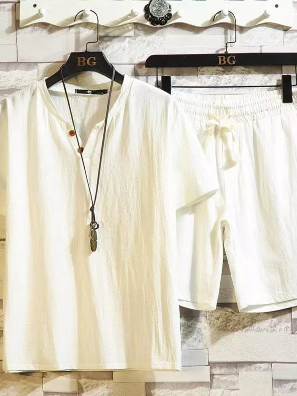 White cotton two-piece set with drawstring shorts and henley neckline shirt.