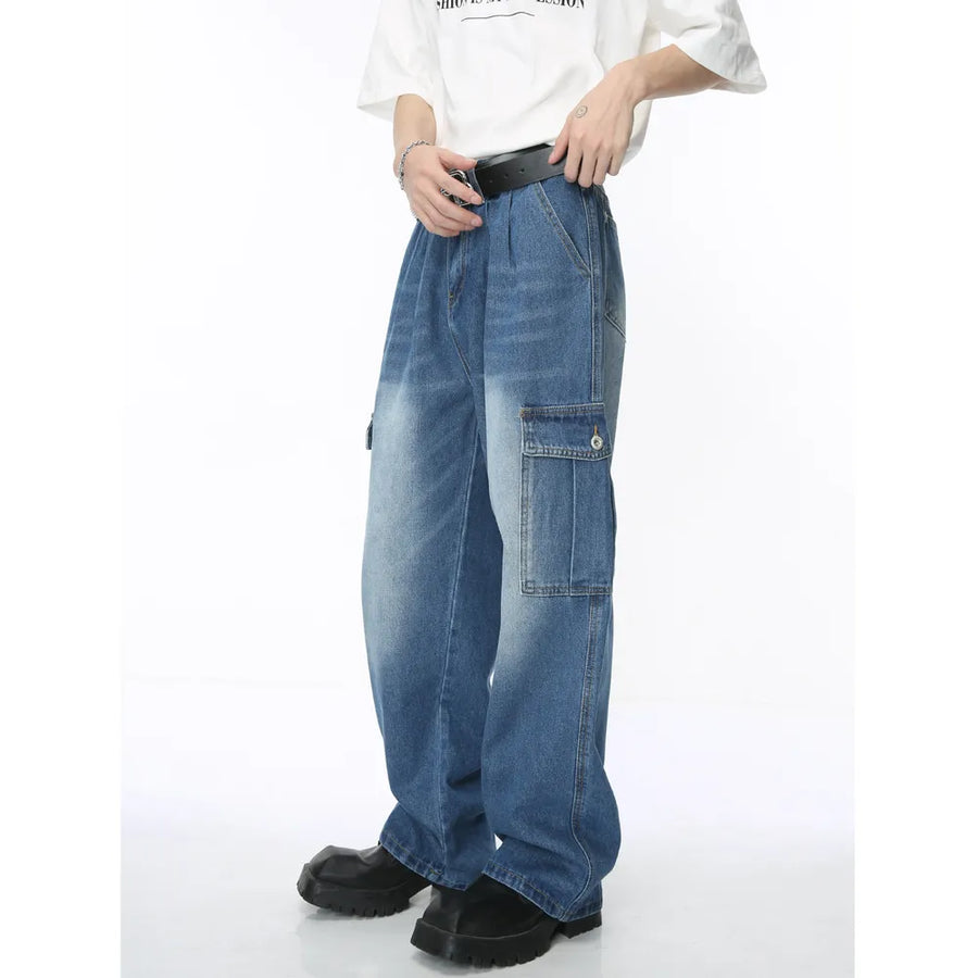 Pleated wide-leg denim cargo pants in medium wash with utility pockets.