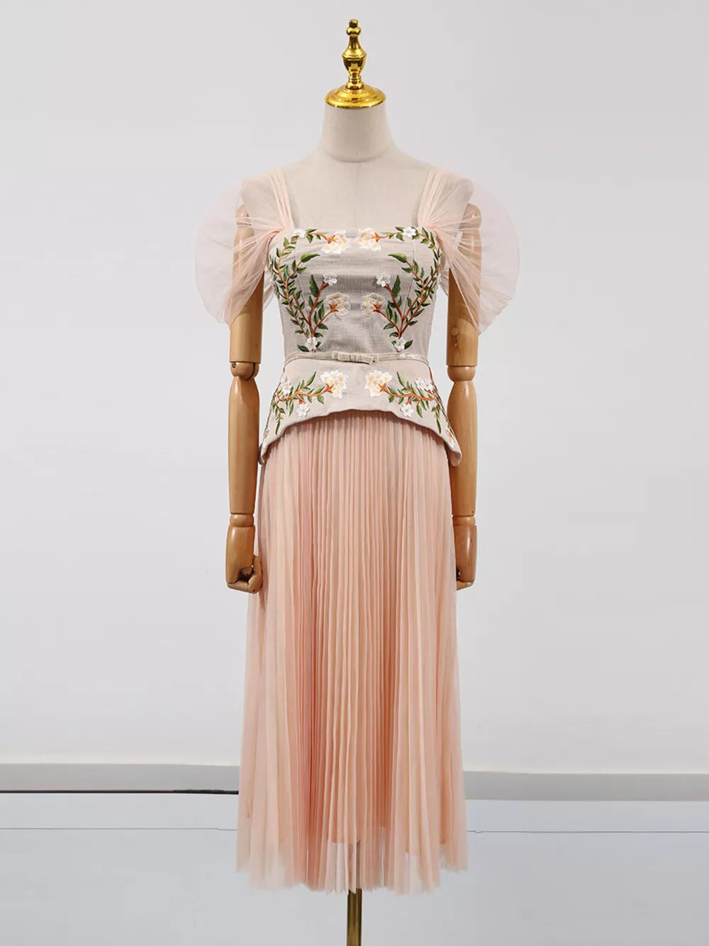 Pink embroidered tulle midi dress with sheer puff sleeves and square neckline.