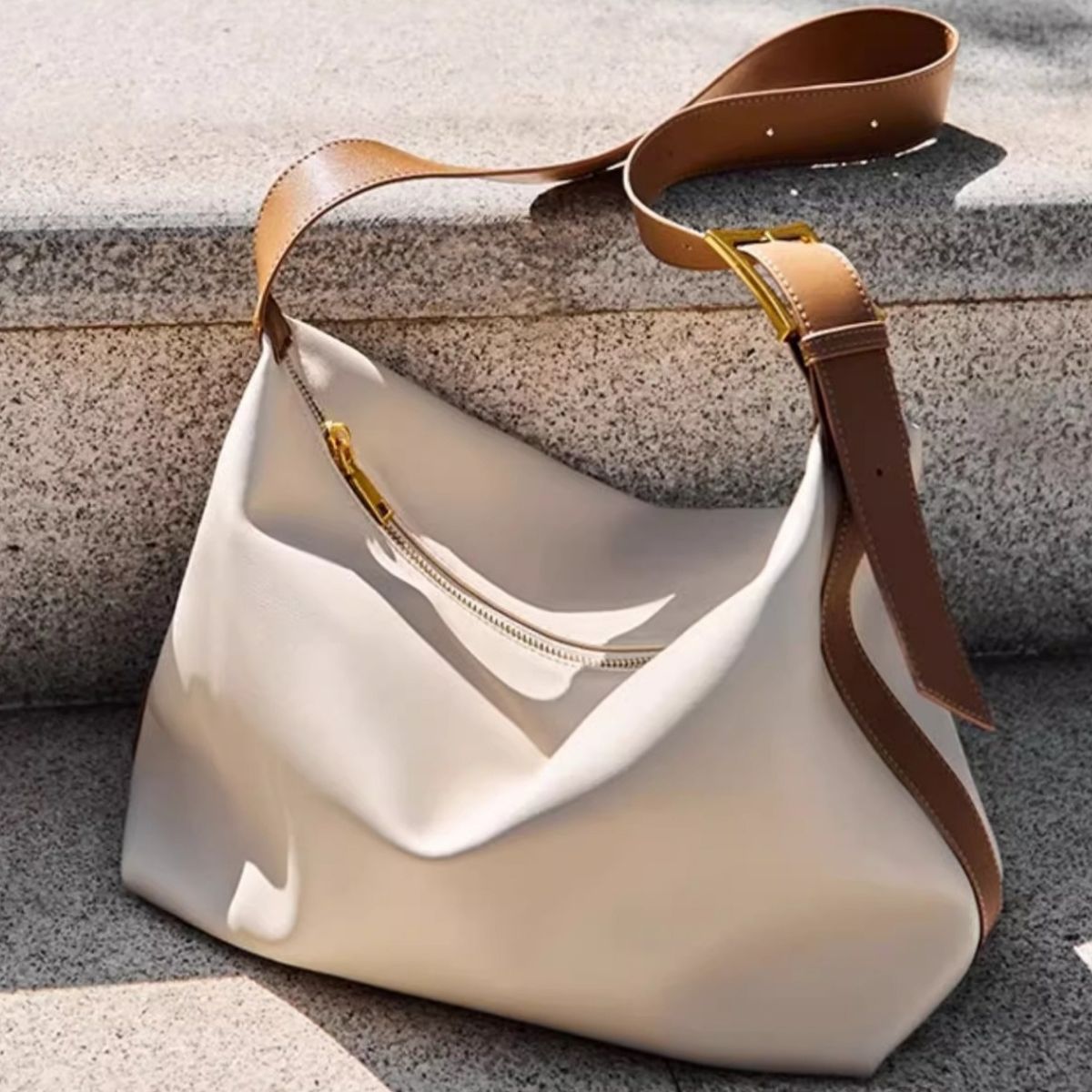 White pu leather shoulder bag with brown strap and gold buckle detail