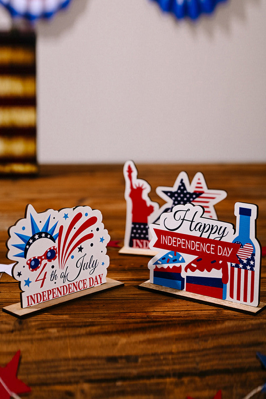 Patriotic Americana wooden tabletop decor with 4th of July, Statue of Liberty, and happy Independence Day designs.