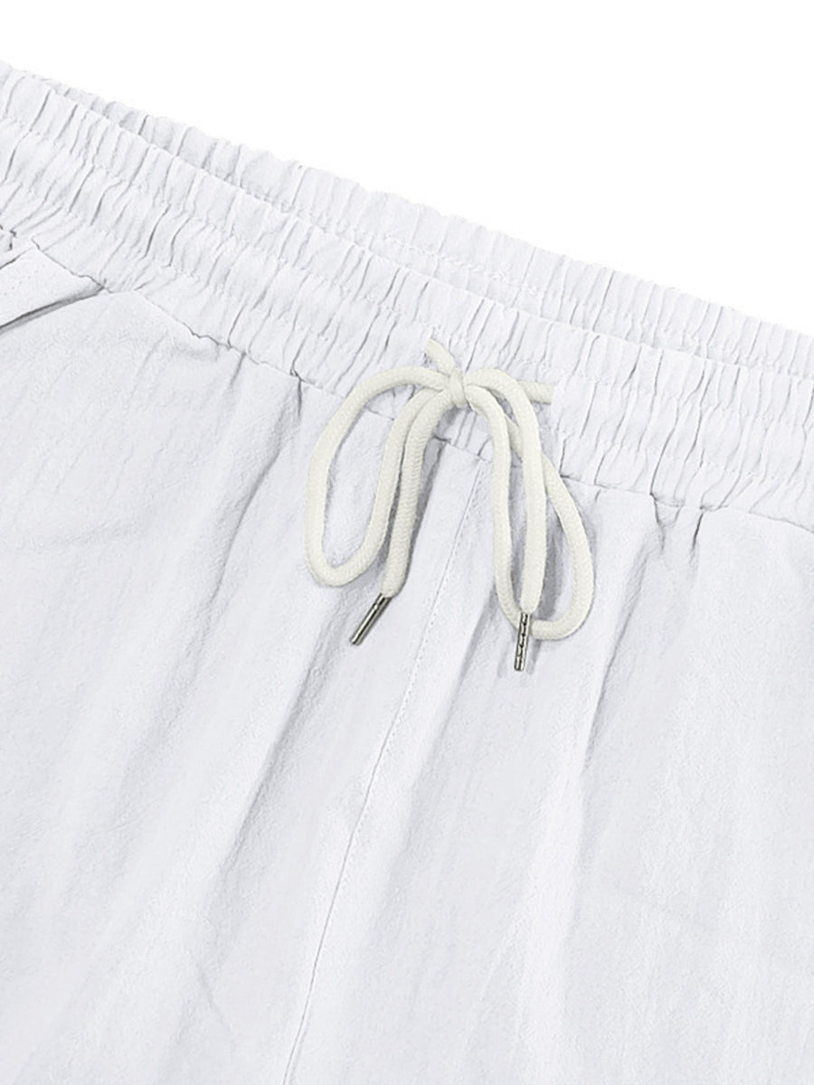 White cargo sweatpants with drawstring waist and metal-tipped cords.