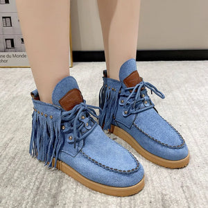 Blue denim moc-toe ankle boots with fringe and studs