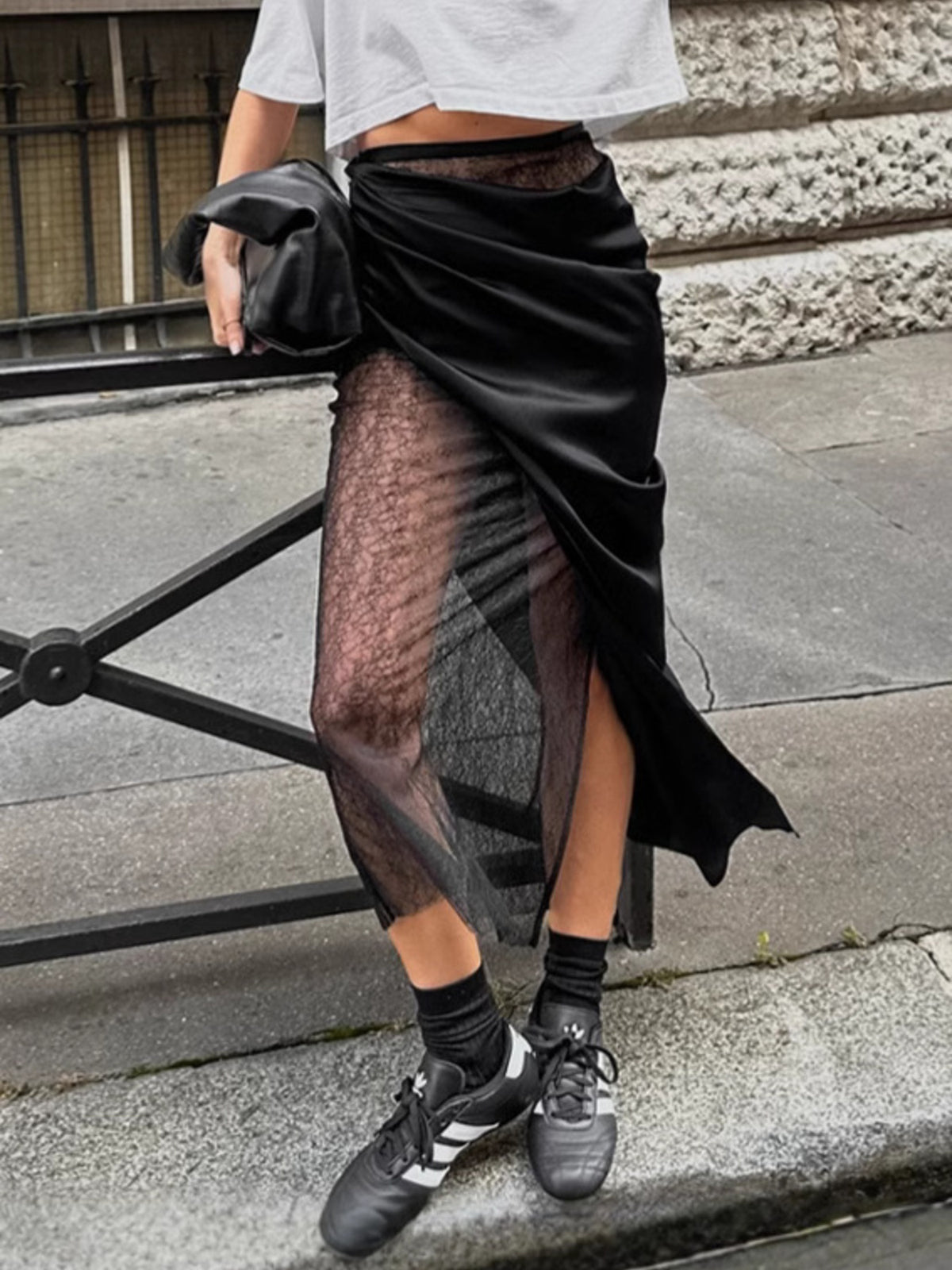 Black midi skirt with sheer lace panel and asymmetrical hem