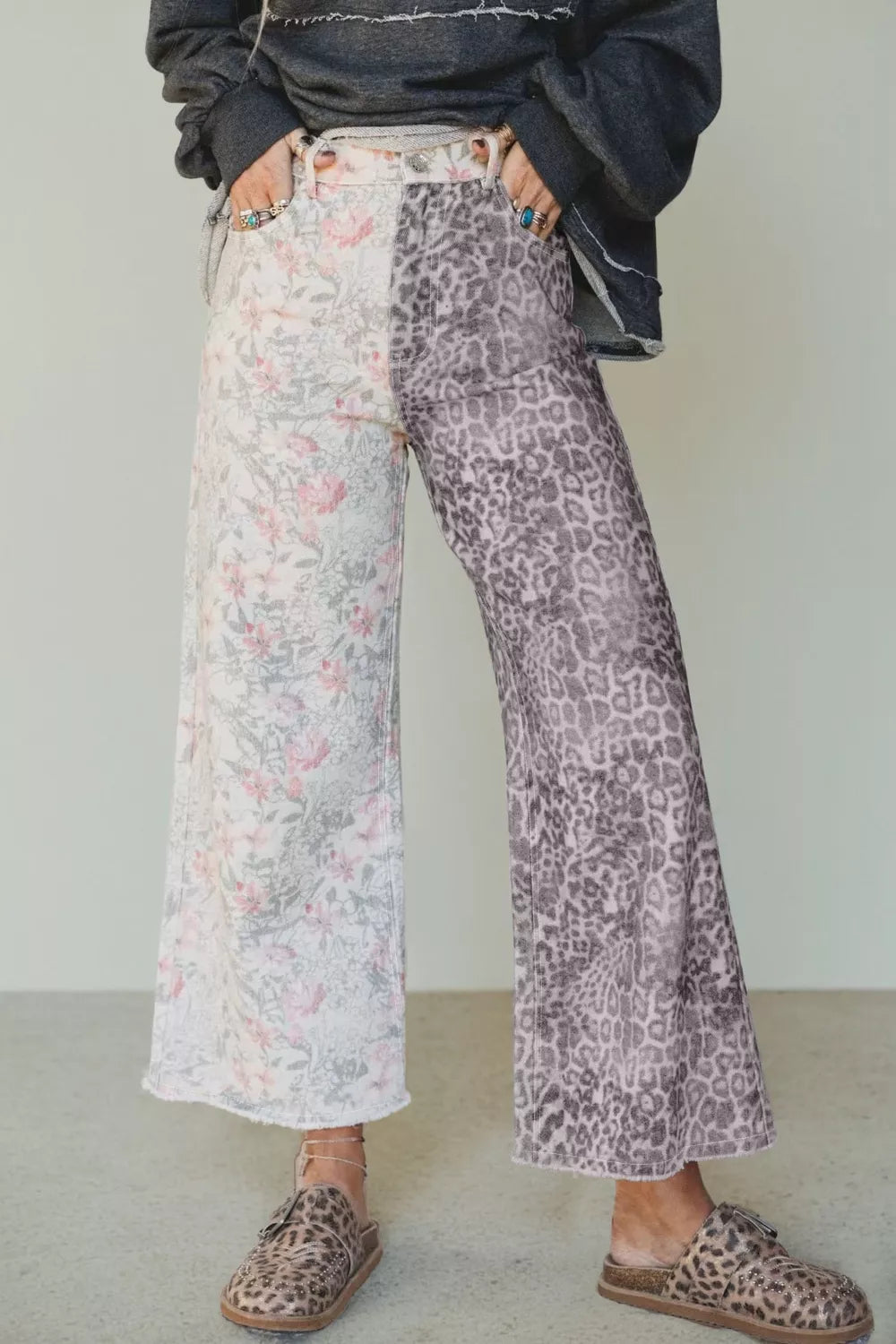 Floral and leopard print wide-leg jeans with raw hem and split design.