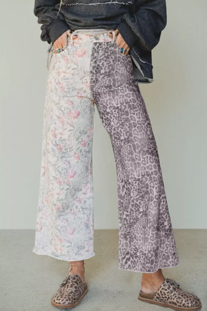 Floral and leopard print wide-leg jeans with raw hem and split design.