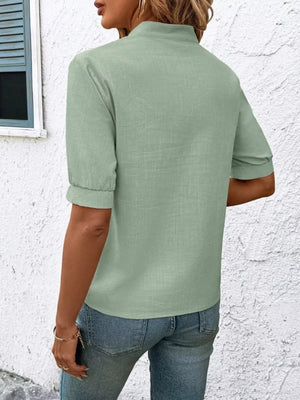 Green embroidered notched blouse with cuffed sleeves and a stand collar.