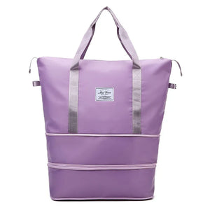 Expandable travel tote bag in lavender with contrast trim and dual handles.