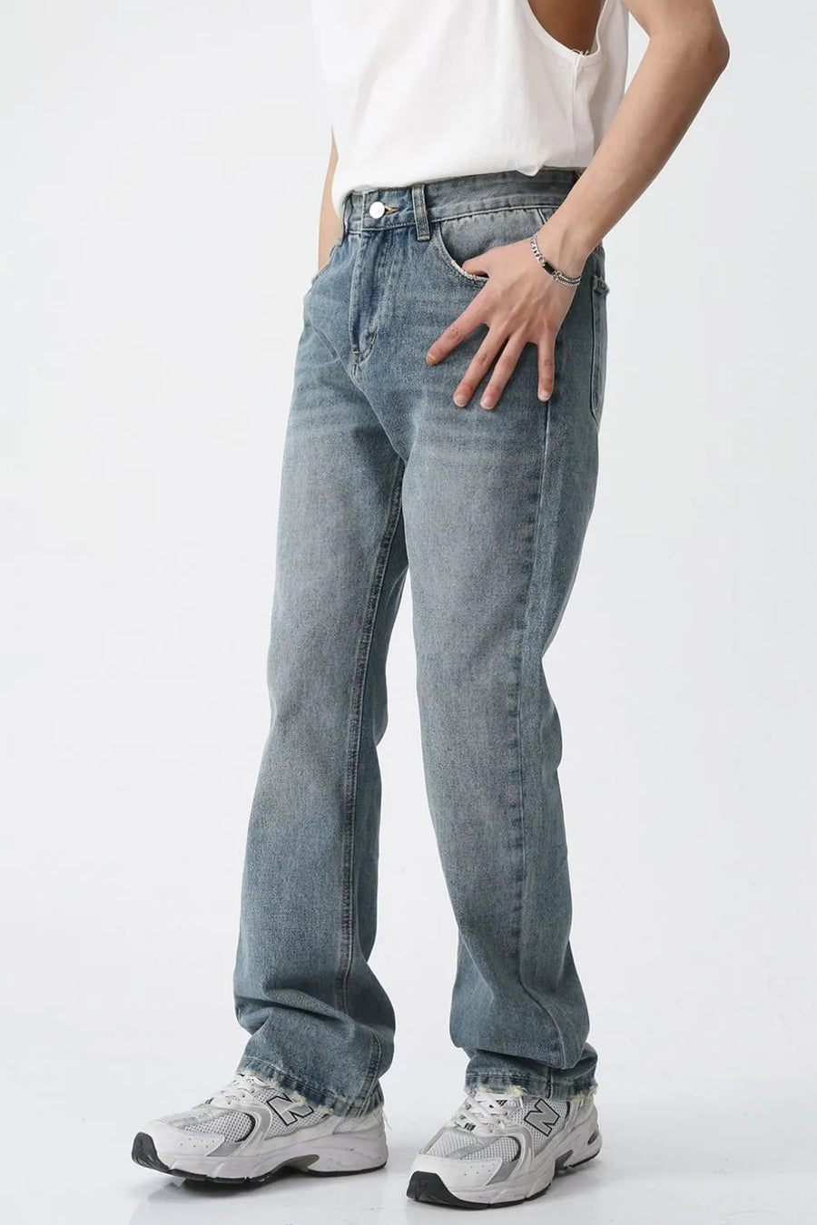 Relaxed wash straight leg denim jeans in medium blue, styled casually.