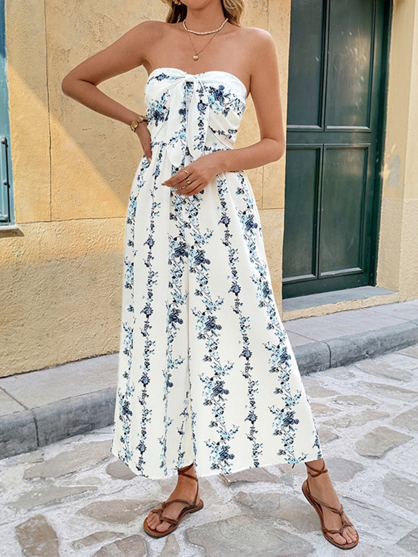 Floral smocked tie-front wide-leg romper in white with blue floral print.