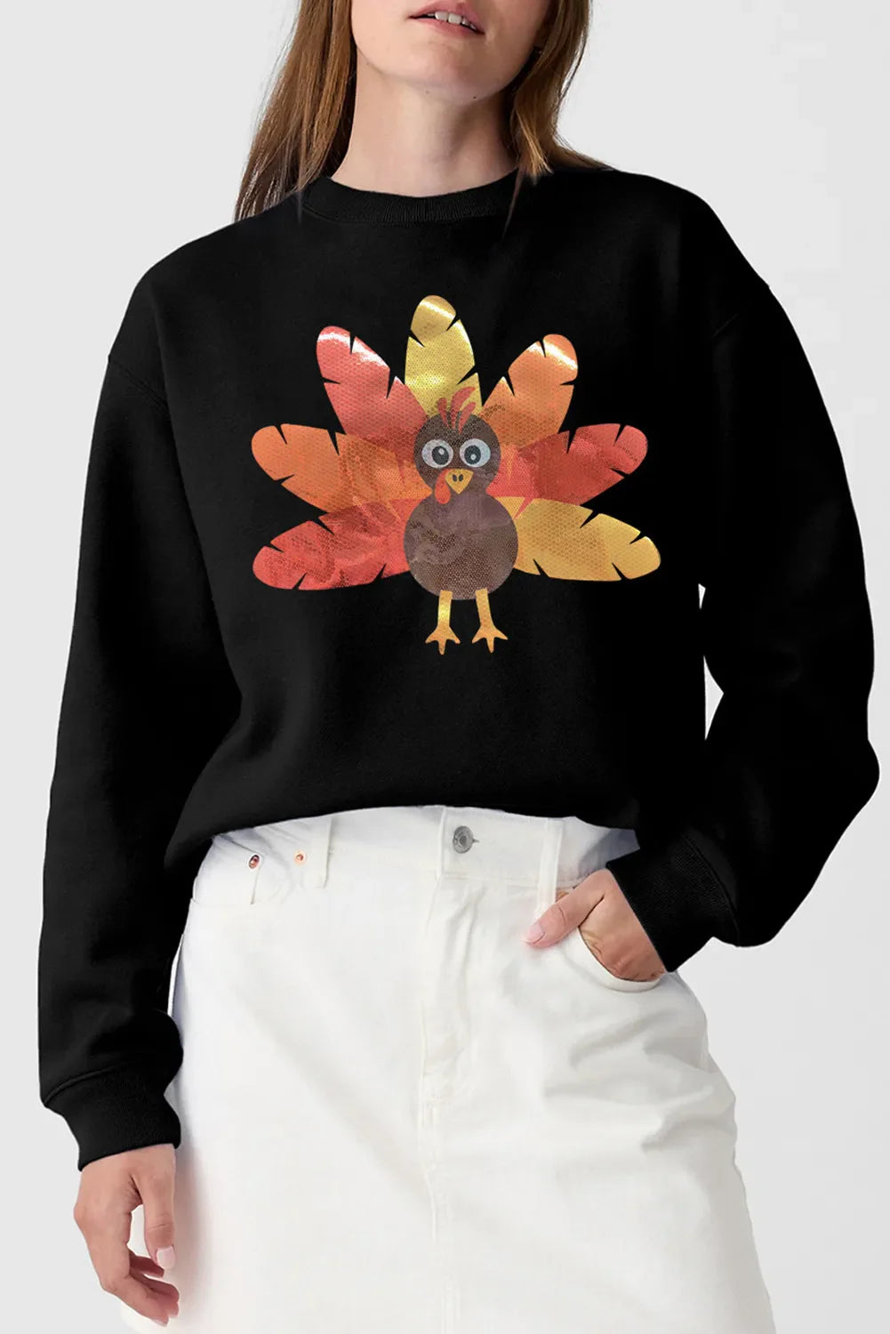 Black crewneck sweatshirt with a cartoon turkey graphic and colorful tail feathers.