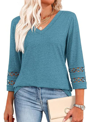 Blue 3/4 sleeve t-shirt with V-neck and cutout detail on sleeves.