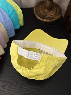 Yellow cotton baseball cap with adjustable strap and brim detail