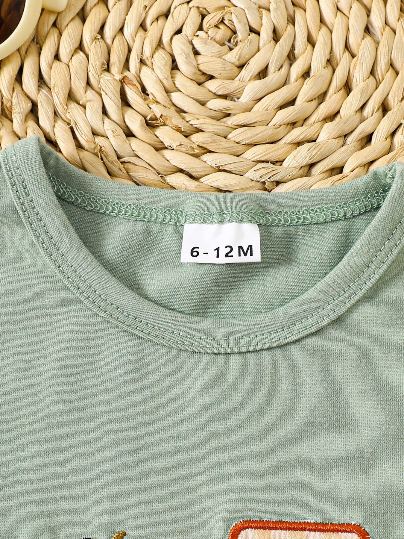 Light green cotton baby tee with embroidered tractor detail and crew neck.