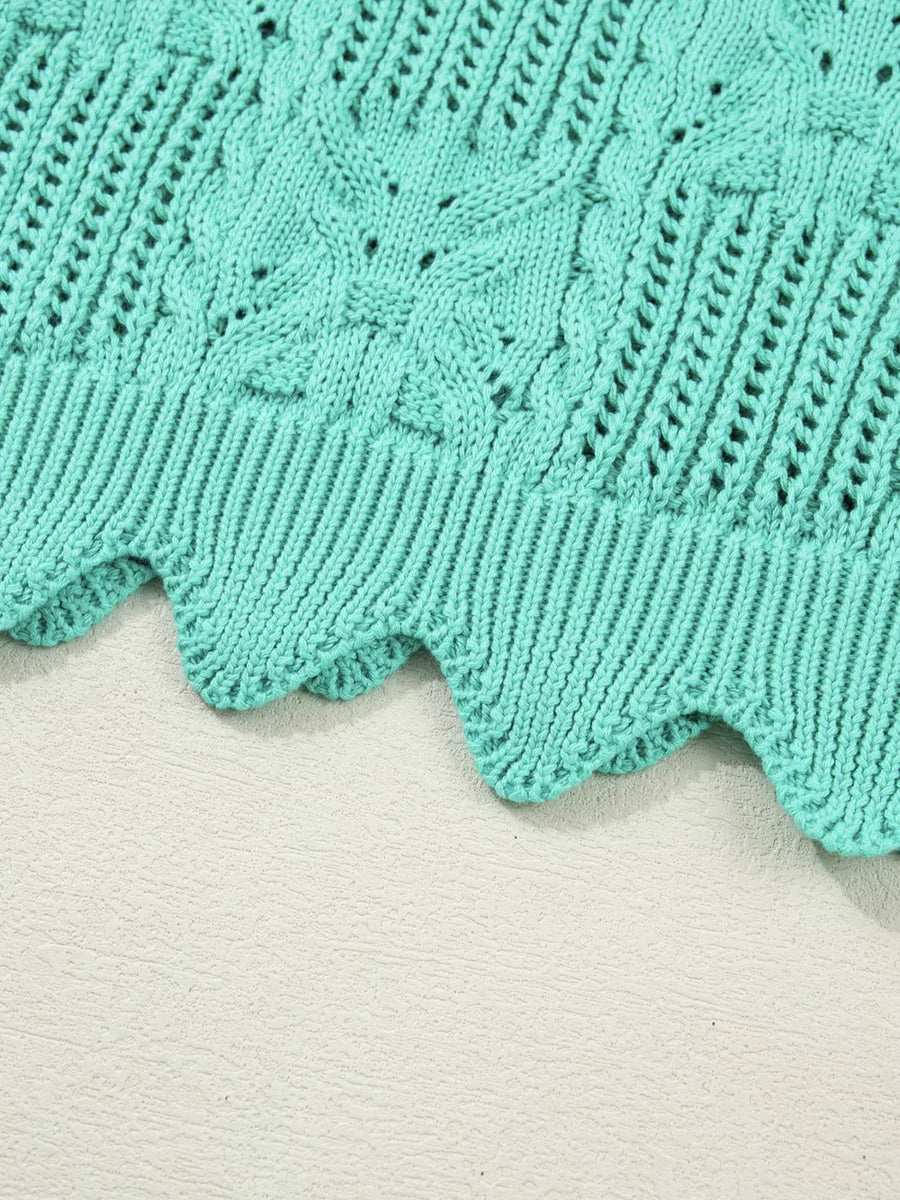 Pointelle knit sweater in teal with scalloped trim and cable knit details.