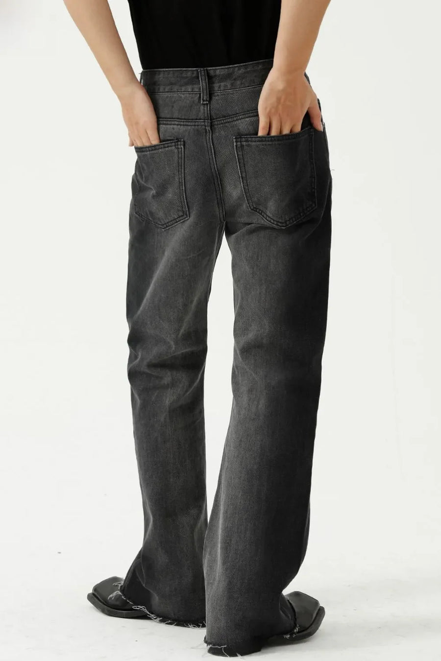 Dark wash cotton flare jeans with raw hem and seam details