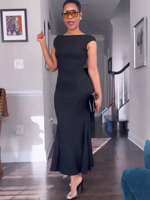 Black cap sleeve maxi gown with boat neckline and backless detail.